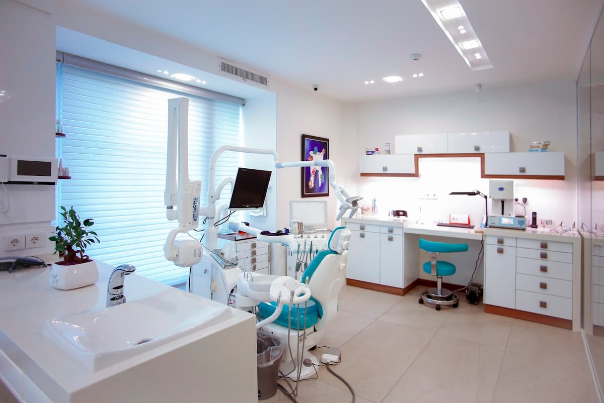 Bright, modern medical clinic treatment room with white interiors