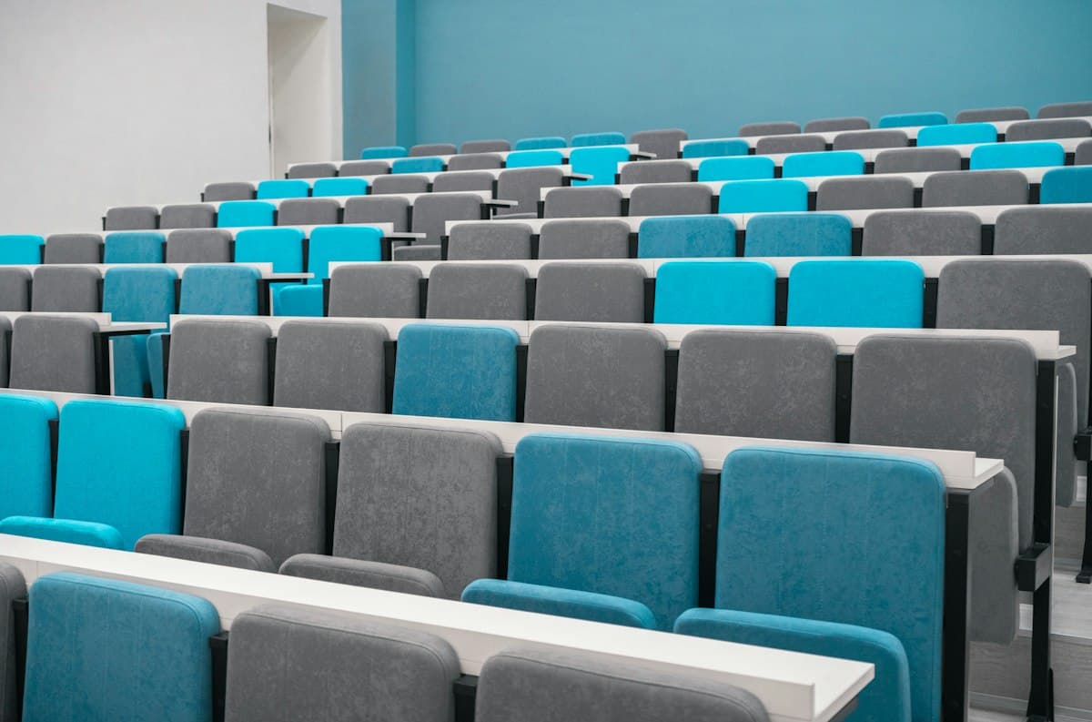 Modern lecture hall with rows of blue and grey seats